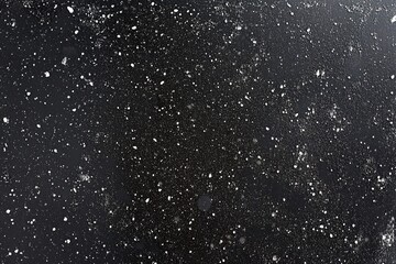 Scattered Snowflakes on Dark Surface