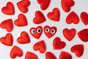 Set of red love hearts as decoration on white background.Hearts with googly eyes close to each other as symbol of warm relation