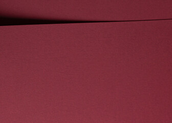 Dark red and burgundy paper texture with a matte finish. Rich, fancy material featuring a