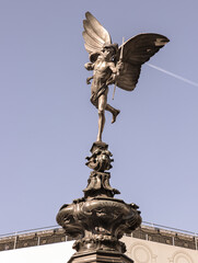 Fototapeta premium The Statue of Eros is The Greek god anteros (the Greek God of love)? that sits atop of the Shaftesbury memorial fountain is bronze with sky in the background, is a cast aluminium sculpture with winged