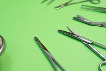 Naklejka premium Set of Surgery Instrument over Green background. Include Scissors and forceps. Medical equipment kit