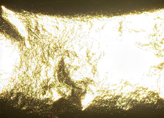 Luxurious gold foil texture with a glossy, pearlescent finish. Shiny, gleaming surface with a