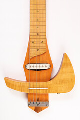 Electric slide guitar, tinted in yellow tones and covered with shellac
