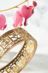 Gold Filigree Bracelet with Bleeding Heart Flowers on Marble
