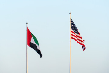 USA and UAE flags are blown in the wind