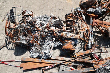 A car is in a junkyard with a lot of debris and rusted parts