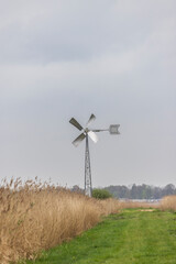 Nature Landscape with small windmill along Burgumer lake in Friese wouden bij Eastermar in The Netherlands