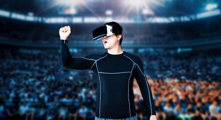 Skilled gamer with VR headset celebrate his victory in video game. Professional player using augmented reality technology and winning the game while standing at stadium with inspectors. Ingenuity. © InfiniteFlow