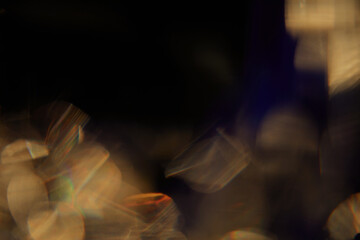 Abstract light leaks on black background with copy space. Studio lens flare bokeh effect.