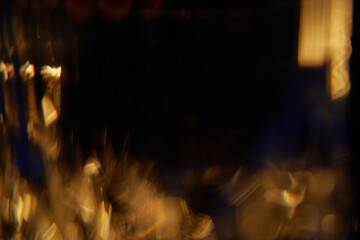 Abstract light leaks on black background with copy space. Studio lens flare bokeh effect.