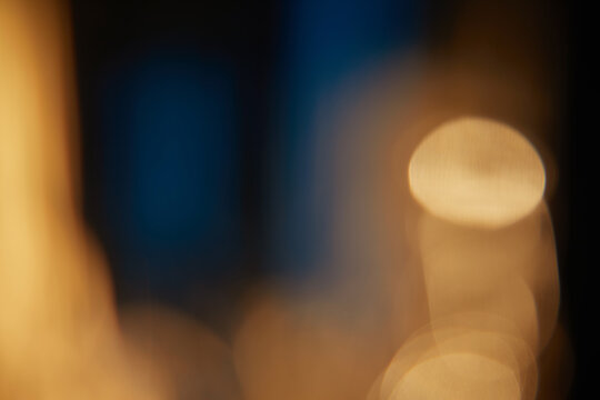 Abstract light leaks on black background with copy space. Studio lens flare bokeh effect.