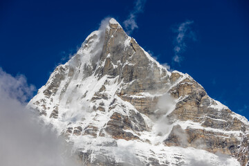 Mera Peak high altitude mountain summit ascent in Himalayas. Stunning views above the clouds at sunrise from the top of the mountain. Alpine route climbing on the snow path in Himalayas