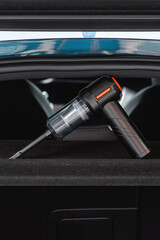 Handheld Car Vacuum Cleaner Resting in a Car Interior © eugenivy