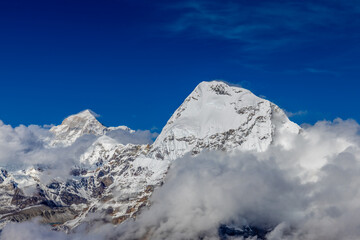 Mera Peak high altitude mountain summit ascent in Himalayas. Stunning views above the clouds at sunrise from the top of the mountain. Alpine route climbing on the snow path in Himalayas