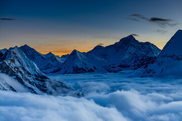 Mera Peak high altitude mountain summit ascent in Himalayas. Stunning views above the clouds at sunrise from the top of the mountain. Alpine route climbing on the snow path in Himalayas