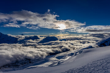 Mera Peak high altitude mountain summit ascent in Himalayas. Stunning views above the clouds at sunrise from the top of the mountain. Alpine route climbing on the snow path in Himalayas