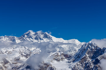 Mera Peak high altitude mountain summit ascent in Himalayas. Stunning views above the clouds at sunrise from the top of the mountain. Alpine route climbing on the snow path in Himalayas