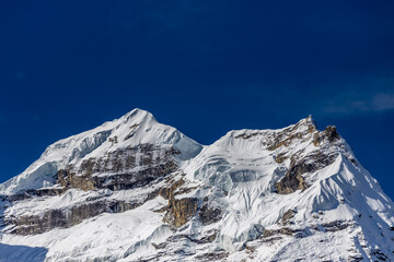 Mera Peak high altitude mountain summit ascent in Himalayas. Stunning views above the clouds at sunrise from the top of the mountain. Alpine route climbing on the snow path in Himalayas