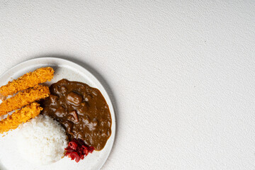 Japanese curry rice with crispy deep fried shrimp ebi furai and rich brown sauce on a plate