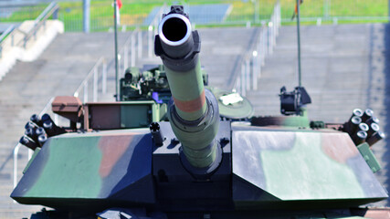 Heavy military tank vehicle turret gun aiming on a target and ready to fire. The rotating turret...