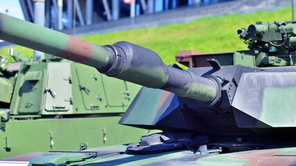 Heavy military tank vehicle turret gun aiming on a target and ready to fire. The rotating turret...