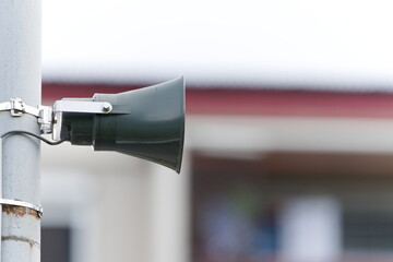 Town broadcast speaker siren in residential area in small city. Emergency sirens are tested every...