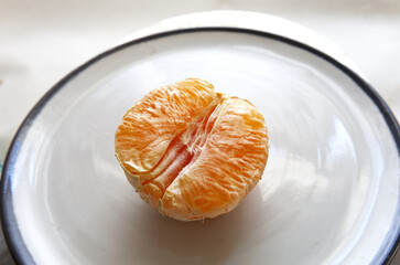 peeled orange on a plate