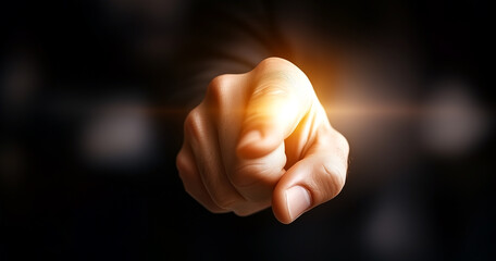 A hand pointing with a magical glowing effect at the fingertip suggesting innovation a brilliant idea or a touch of transformative power in concepts