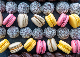 Macarons and coconut balls in order on plate