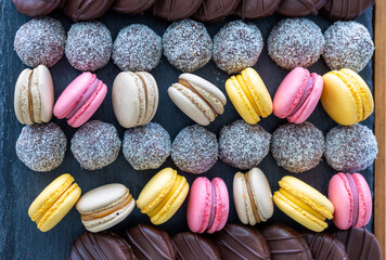 Macarons and coconut balls in order on plate