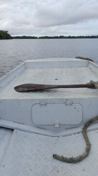POV sailing in speedboat or canoe through the flooded forest in Amazon River. Front view of boat crossing igap&oacute;s, lake stream, sea, ocean. Kayaking in the jungle, rainforest. Paddle and rope in dock.