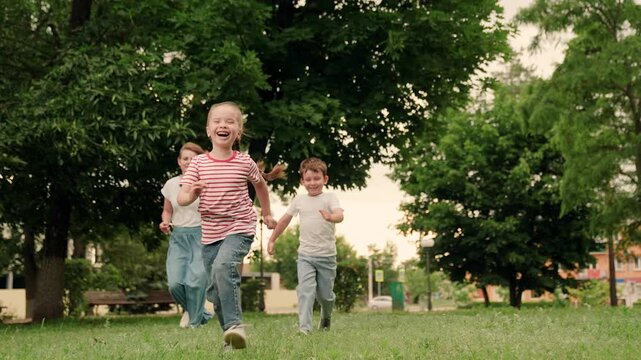 Happy family, daughter son mother laughing, run through park. Joyful kids, mom play, have fun outdoor. Mom, girl boy running in park on summer day. Kids weekend, outdoor games. Concept happy childhood