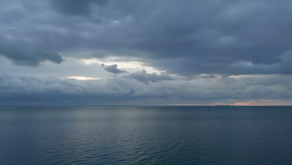 Blue ocean under grey cloudy sky, perfect for backgrounds or travel inspiration.