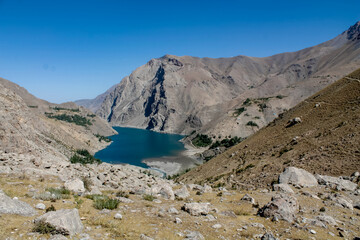 Fann mountains in Pamir Alay, Tajikistan. Dry desert mountain landscape in Middle Asia, lake and trees. Tajikistan Fann mountains lake panorama landscape. Allo, Alauddin and Kulikalon lake in Fans