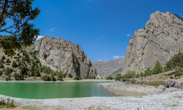Fann mountains in Pamir Alay, Tajikistan. Dry desert mountain landscape in Middle Asia, lake and trees. Tajikistan Fann mountains lake panorama landscape. Allo, Alauddin and Kulikalon lake in Fans