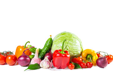 Mix of colorful vegetables - bell pepper, cabbage, tomatoes, cucumbers, onions and garlic. Isolated on white.