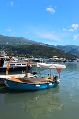 Budva, Montenegro - May 04, 2024: Dukley Marina and Old Town. The old city walls of Budva along the Adriatic coast, Montenegro. On a hot, sunny, spring afternoon.
