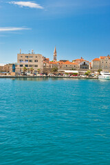 Fototapeta premium Budva, Montenegro - May 04, 2024: Dukley Marina and Old Town. The old city walls of Budva along the Adriatic coast, Montenegro. On a hot, sunny, spring afternoon.
