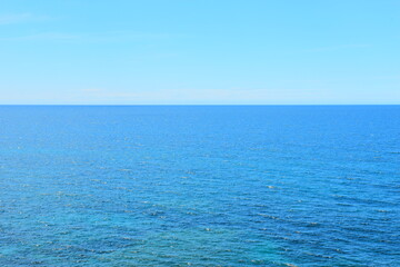 Fototapeta premium Budva, Montenegro - May 04, 2024 : The Old Town Fortress in Budva. A stone wall on the shore of the Adriatic Sea in Montenegro. Horizontal. On a hot, sunny, spring afternoon. 