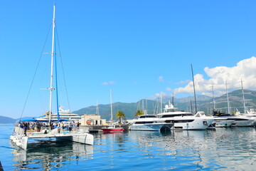 Fototapeta premium Tivat Montenegro 05052024 A walk through the luxury marina Porto Montenegro, luxury houses, luxury yachts, vacation at sea. On a hot, sunny, spring afternoon.