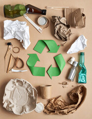 Various recycled materials creatively repurposed into art or useful objects illustrate the concept of waste reduction and reuse.