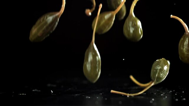 Pickled capers fall on the table. Filmed on a high-speed camera at 1000 fps. High quality FullHD footage