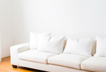 A white couch sitting in a living room next to a wall.