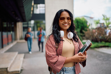Happy Indian female student at campus looking at camera.