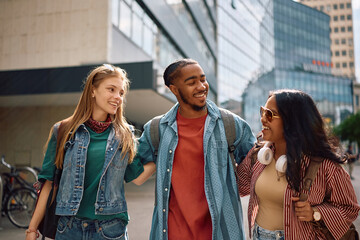 Multiracial group of students walking through campus.