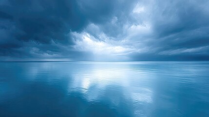 Obraz premium Dramatic Storm Clouds Gather Above Calm Ocean Waters With Sunlight Breaking Through