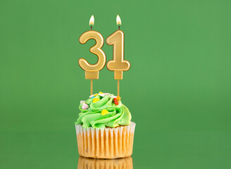 Birthday card with candle and cupcake - Number 31 on a green background