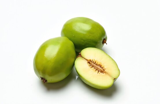 Fresh green umbu fruits Spondias tuberosa isolated white background. Ripe fruits halves reveal juicy pulp, appealing tropical food product. Healthy organic snack diet, vegetarian food. High-quality