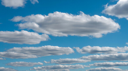 Fototapeta premium Beautiful blue sky with fluffy white clouds on a bright sunny day outdoors