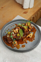 Closeup of Hot Dish with Rich Sauce and Herbs
